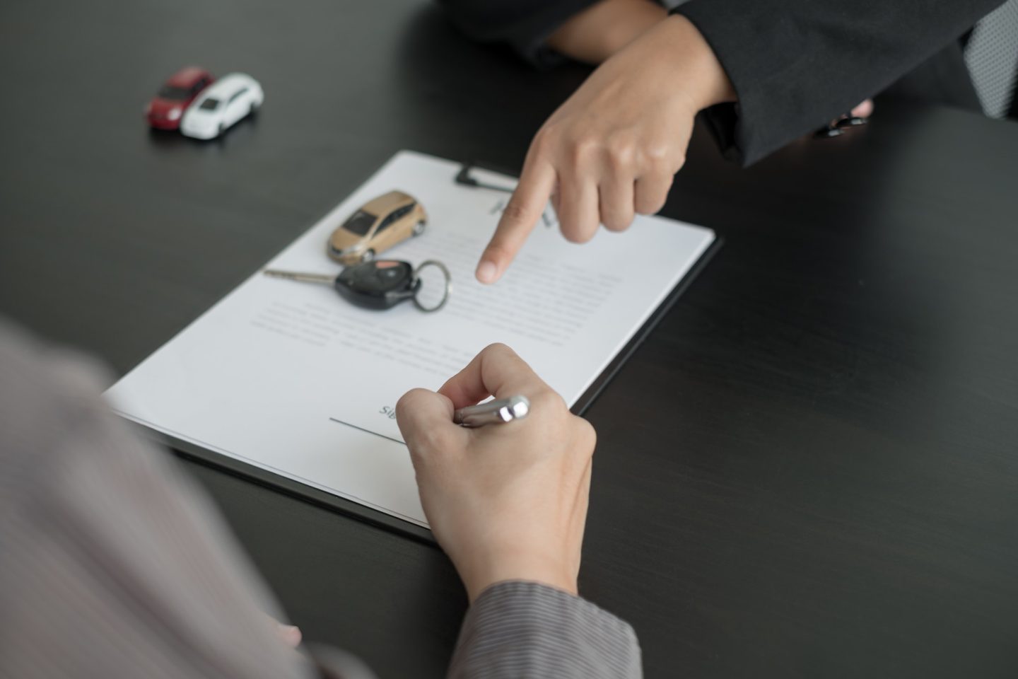 The car dealer provides advice on loans, insurance details, and car rental information, and delivers