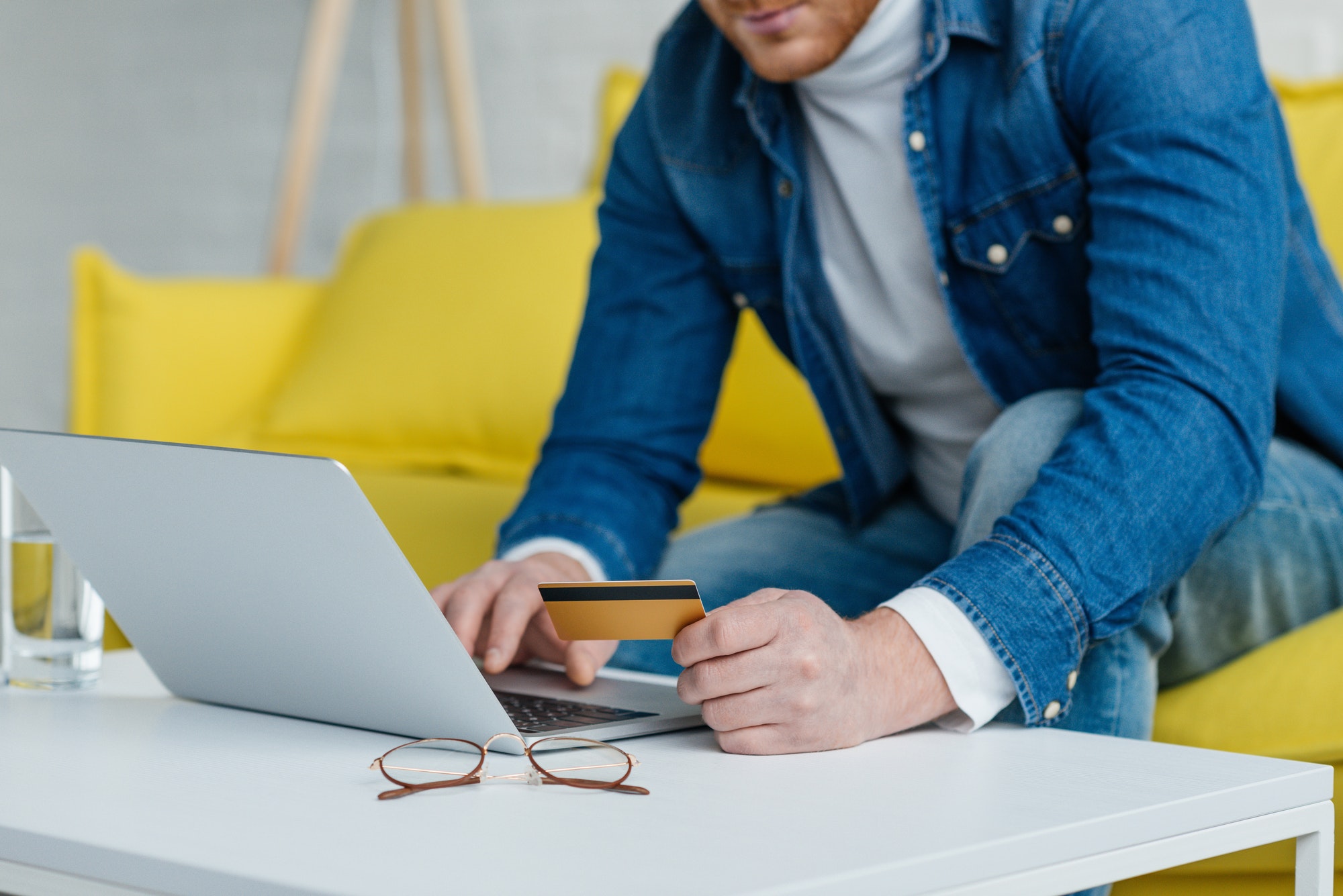 Man making online payment with credit card and laptop