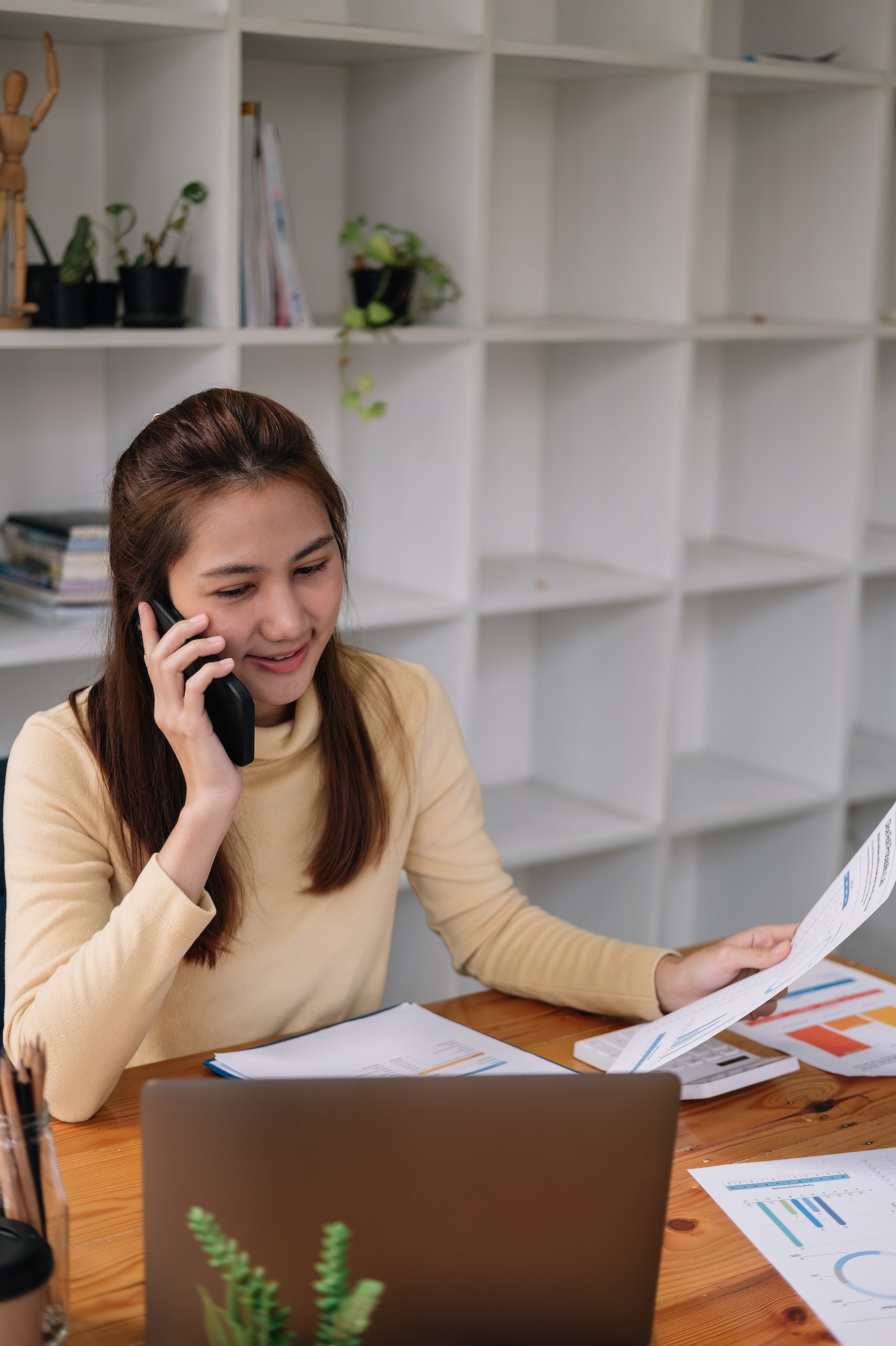 Asian business woman making a phone call, Accountant working Financial investment on calculator with