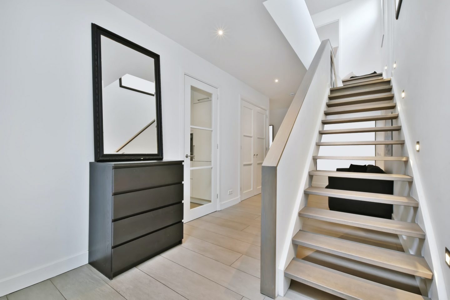 The corridor is in a minimalist style with a comfortable staircase