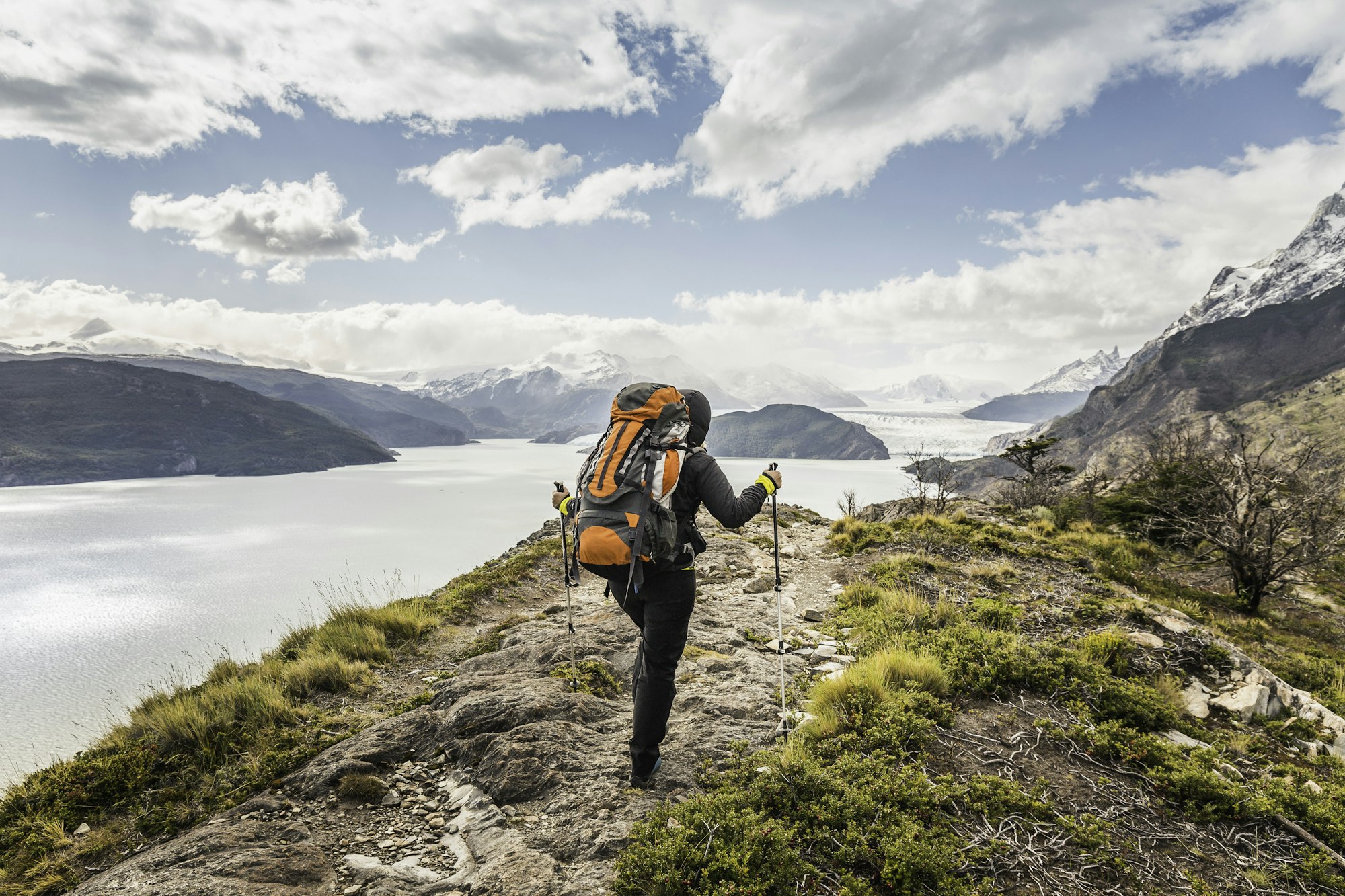 rear-view-of-female-hiker-hiking-alongside-grey-glacier-lake-torres-del-paine-national-park-chile.jpg